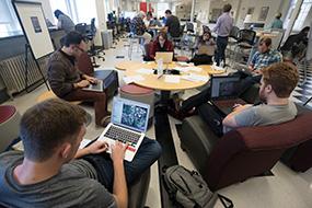 Digital Business Strategy group of people sitting around a table with laptops