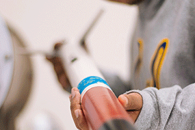 Student holding model rocket