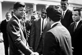 Vintage photograph of President John F Kennedy shaking hands with a group of men