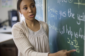 Woman writing on chalkboard