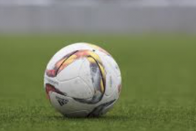 Soccer ball with swirl color patterns on a field