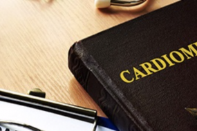 Hardcover book with the word "Cardiomegaly" laying on a table